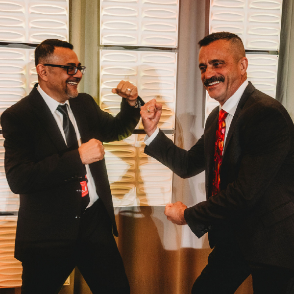 two people raising fists pretending to fight